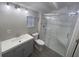 Modern bathroom with marble shower and gray vanity at 2205 12Th Nw St, Winter Haven, FL 33881