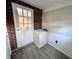 Laundry area with vinyl flooring and brick wall at 2205 12Th Nw St, Winter Haven, FL 33881