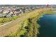 Aerial view of the house and surrounding community near a lake at 2271 Garden Belle Dr, Clermont, FL 34711