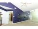 Primary bedroom with purple walls, mirrored wall, and built-in shelves at 259 New Waterford Pl, Longwood, FL 32779