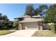 Two-story home with attached garage and landscaped front yard at 259 New Waterford Pl, Longwood, FL 32779