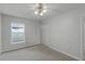 Bedroom with grey carpet, a ceiling fan, and double door closet at 5012 Ayres Dr, Orlando, FL 32824