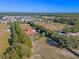 Aerial view of a home on a large lot with surrounding trees and open space at 502 W Lester Rd, Apopka, FL 32712