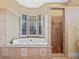 Bathroom with soaking tub, walk-in shower, and window at 502 W Lester Rd, Apopka, FL 32712