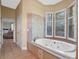 Bathroom with soaking tub, walk-in shower, and window at 502 W Lester Rd, Apopka, FL 32712