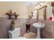 Elegant bathroom with pedestal sink and decorative accents at 502 W Lester Rd, Apopka, FL 32712