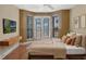 Spacious bedroom with hardwood floors and French doors leading to a balcony at 502 W Lester Rd, Apopka, FL 32712