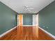 Bright bedroom with hardwood floors and multiple doors at 502 W Lester Rd, Apopka, FL 32712