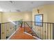 Elegant hallway with hardwood floors and wrought iron railing at 502 W Lester Rd, Apopka, FL 32712