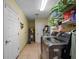 Laundry room with washer, dryer, and storage shelves at 502 W Lester Rd, Apopka, FL 32712