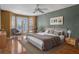 Main bedroom with hardwood floors and access to a balcony at 502 W Lester Rd, Apopka, FL 32712