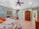 Main bedroom with king bed, sitting area, and access to bathroom at 502 W Lester Rd, Apopka, FL 32712