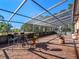 Relaxing screened patio with seating area and lush landscaping at 502 W Lester Rd, Apopka, FL 32712