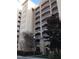 Exterior view of a multi-story building with balconies and landscaping at 6336 Buford St # 203, Orlando, FL 32835