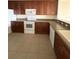 Kitchen features dark wood cabinets, granite countertops, and white appliances at 6336 Buford St # 203, Orlando, FL 32835