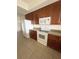 Kitchen with dark wood cabinets, white appliances, and granite countertops at 6336 Buford St # 203, Orlando, FL 32835