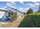 Landscaped backyard with a shed and a screened enclosure at 6524 Sw 108Th Pl, Ocala, FL 34476