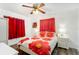 Bedroom with red floral bedding and ceiling fan at 6524 Sw 108Th Pl, Ocala, FL 34476