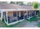 Damaged screened porch with debris and overgrown plants at 99 Eastridge Dr, Eustis, FL 32726