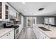 Modern kitchen with white cabinets, granite countertops, and island seating at 15321 Beamleigh Rd, Winter Garden, FL 34787