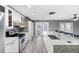 Modern kitchen featuring white cabinets, granite countertops, and stainless steel appliances at 15321 Beamleigh Rd, Winter Garden, FL 34787