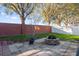 Landscaped backyard with fire pit and brick wall at 1813 Sugar Cove Ct, Ocoee, FL 34761
