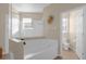 Relax in this spa-like bathroom, featuring a large soaking tub and shower at 1813 Sugar Cove Ct, Ocoee, FL 34761