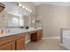 Double vanity bathroom with a large mirror and separate tub at 1813 Sugar Cove Ct, Ocoee, FL 34761