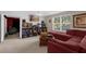 Game room boasts arcade games, sectional sofa, and a large window at 1813 Sugar Cove Ct, Ocoee, FL 34761