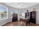 Bright home office with built-in shelves, a desk, and large windows at 1813 Sugar Cove Ct, Ocoee, FL 34761