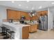 Modern kitchen with stainless steel appliances and an island with seating at 1813 Sugar Cove Ct, Ocoee, FL 34761