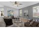 Relaxing living room with two armchairs, a couch, and a glass coffee table at 1813 Sugar Cove Ct, Ocoee, FL 34761