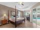 Spacious main bedroom with a four-poster bed and pool view at 1813 Sugar Cove Ct, Ocoee, FL 34761
