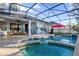 Large pool and spa with a covered patio and red umbrella at 1813 Sugar Cove Ct, Ocoee, FL 34761