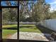 View of backyard through screened patio at 1884 Hickory Bluff Rd, Kissimmee, FL 34744