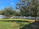 Fenced backyard with mature trees and grass at 1884 Hickory Bluff Rd, Kissimmee, FL 34744