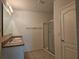 Bathroom with double vanity, shower, and tile flooring at 1884 Hickory Bluff Rd, Kissimmee, FL 34744