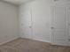 Empty bedroom with neutral walls and carpet, featuring two doors at 1884 Hickory Bluff Rd, Kissimmee, FL 34744