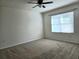 Spacious bedroom with ceiling fan and large window at 1884 Hickory Bluff Rd, Kissimmee, FL 34744