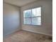 Small bedroom with carpeted floor and window with blinds at 1884 Hickory Bluff Rd, Kissimmee, FL 34744