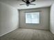 Well-lit bedroom with ceiling fan and window coverings at 1884 Hickory Bluff Rd, Kissimmee, FL 34744