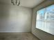 Bright dining room with large window and neutral carpeting at 1884 Hickory Bluff Rd, Kissimmee, FL 34744