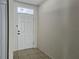 Front entry with white door and tiled floor at 1884 Hickory Bluff Rd, Kissimmee, FL 34744