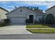 One-story house with attached garage, landscaping, and driveway at 1884 Hickory Bluff Rd, Kissimmee, FL 34744