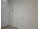 Interior hallway with white doors and tiled floor at 1884 Hickory Bluff Rd, Kissimmee, FL 34744