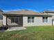Tan house exterior with screened patio and yard at 1884 Hickory Bluff Rd, Kissimmee, FL 34744