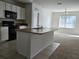 Kitchen with island, black appliances, and white cabinets at 1884 Hickory Bluff Rd, Kissimmee, FL 34744