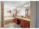 Double vanity bathroom with granite countertops and a soaking tub at 4738 Sleepy Hollow Dr, Kissimmee, FL 34746