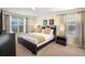 Bright bedroom featuring a king bed, large windows, and stylish decor at 4738 Sleepy Hollow Dr, Kissimmee, FL 34746
