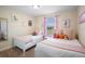 Charming bedroom with two twin beds, decorative pillows, and wall art at 4738 Sleepy Hollow Dr, Kissimmee, FL 34746